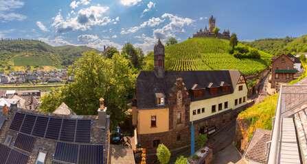 View of Reichsburg above vineyards and rooftops in Cochem, Germany