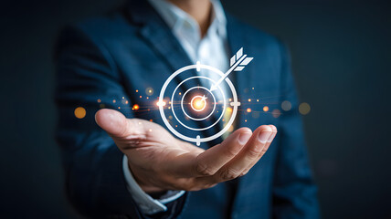 Businessman's hand presents a target with an arrow for achieving business goals and reaching marketing targets for future success.