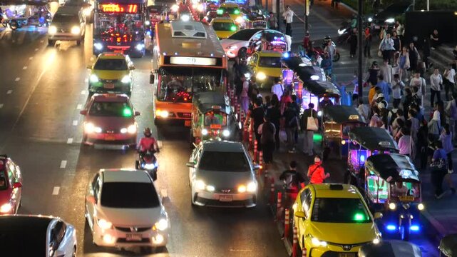 Tuk Tuk taxis, metered taxis and buses at bus stop in Bangkok