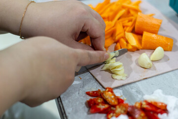 Hands preparing fresh vegetables for cooking
