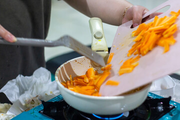 Cooking chopped carrot vegetables in a kitchen
