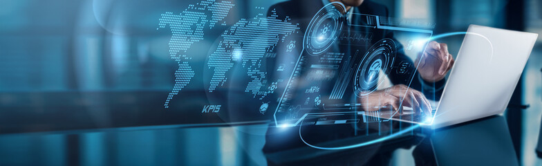 A businessman using a laptop analyzes KPIs to drive strategic growth on a global network, focusing...