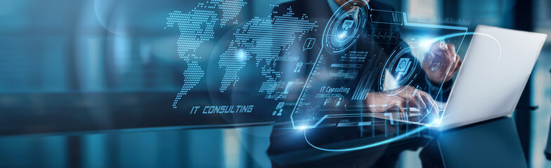 A businessman using a laptop analyzes IT Consulting data, observing digital transformation growth...