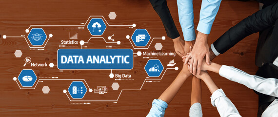 A collaborative team focuses on data analytics concepts, showcasing hands over infographics that illustrate key aspects of statistics, machine learning, and big data analysis. Amity