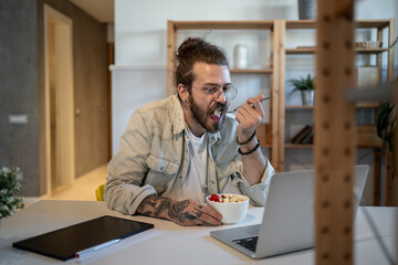 Freelancer enjoying breakfast and working remotely from home office