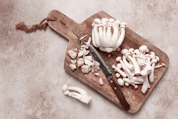 Freshly sliced Shimizhi mushrooms, on a wooden chopping board, ready to cook, close-up, no people,