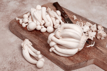 Freshly sliced Shimizhi mushrooms, on a wooden chopping board, ready to cook, close-up, no people,