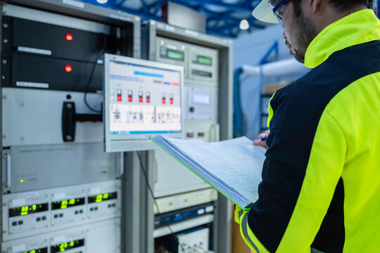 Electrical engineer woman checking voltage at the Power Distribution Cabinet in the control room,preventive maintenance Yearly,Thailand Electrician working at company