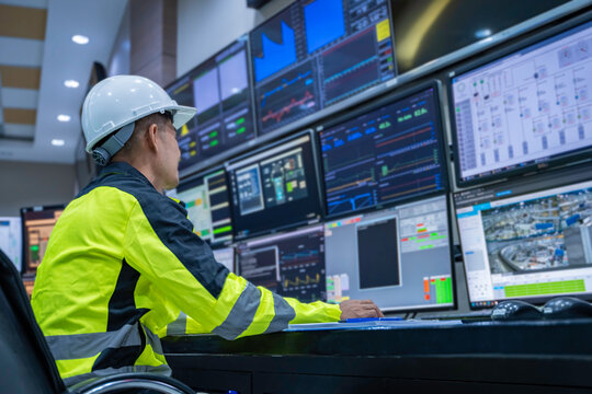 Engineer working at control room, Manager control system, Technician man monitoring program from a lot of monitor.
Specialist observes analytics dashboard,operator inspects digital interface