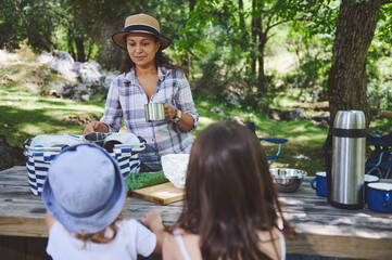 Family Enjoying Outdoor Picnic Surrounded by Nature