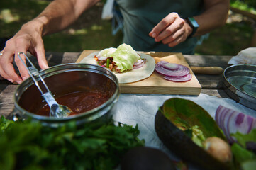 Close-Up of Outdoor Picnic Scene with Fresh Wrap Preparation