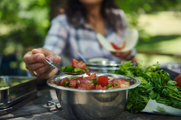 Close-Up of Fresh Vegetable Salad Being Served Outdoors on a Sunny Day
