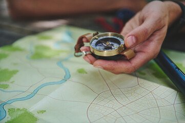 Traveler Holding a Compass Over a Map Highlights Navigation and Exploration