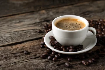 Aromatic espresso coffee cup with roasted beans on rustic wooden surface © Tonay