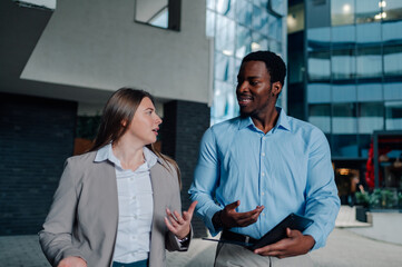 Businesspeople walking and talking outside office building