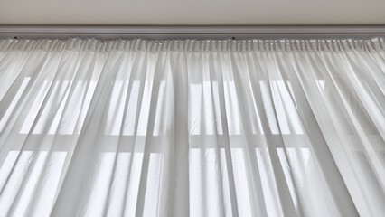 Light through sheer white curtains in a bright room