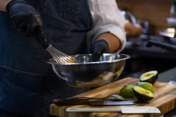 Chef prepares fresh ingredients for appetizers in a bustling kitchen