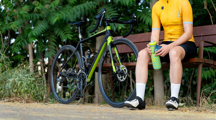 Professional cyclist resting on bench after training session