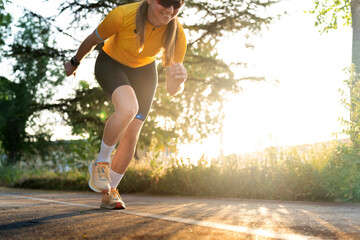 Professional female cyclist starting triathlon race at sunset