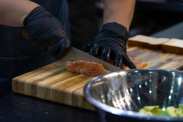 Preparing fresh salmon fillet with precision for a delicious appetizer