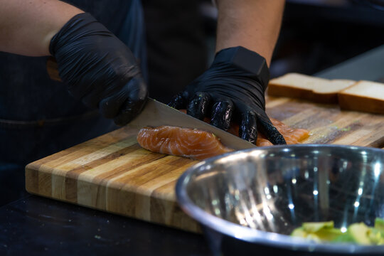 Preparing fresh salmon fillet with precision for a delicious appetizer