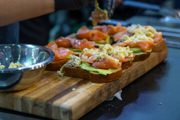 Delicious appetizer preparation in a bustling kitchen during catering service