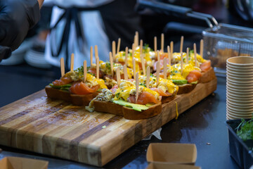 Creative appetizer preparation in a bustling kitchen for a catering event