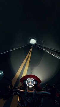 First Person View of Motorcycle Rider Emerging from Tunnel onto an Open Highway Under a Cloudy Sky