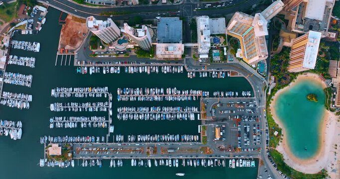 Idyllic sandy beach and large yacht club of Waikiki, Honolulu, Hawaii, USA. Drone footage above the resort area.