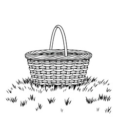 A woven picnic basket on a lawn