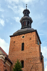Fototapeta premium the belfry of the Gothic, historic parish church in the city of Gniezno