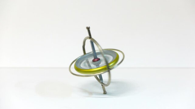 Gyroscope balancing and spinning on white background
