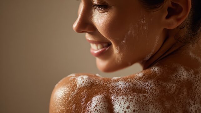 Close up profile capturing woman smiling, washing face and shoulder with soapy lather, embodying personal hygiene and self care wellness moment
