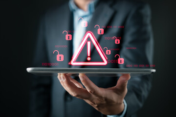 A person holds a tablet displaying red warning icons and open padlocks, symbolizing cybersecurity risks, data breaches, digital threats, and vulnerability in information systems and online networks.