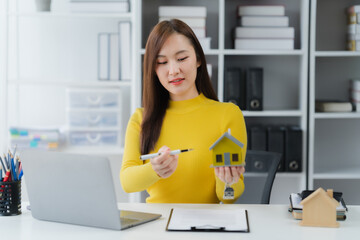 Real Estate Visionary: A focused professional examines a miniature house model in an elegant office...