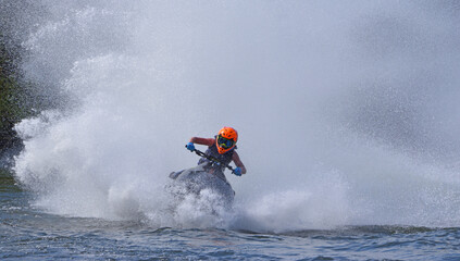 Jet Ski racer cornering at speed making lots of spray 