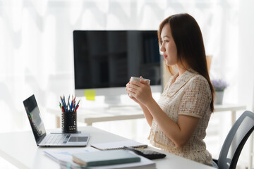 Serene Workday Moment: A person immersed in a moment of calm with laptop, notebook, stationery on a...