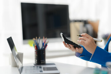 Businesswoman Analyzing Data: A closeup image of a businesswoman meticulously reviewing data on a...