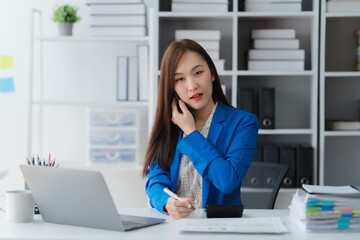 Office Contemplation: A professional woman engrossed in her work, thoughtfully navigating paperwork...