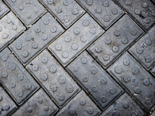 The environmentally friendly pathway made from recycled plastic paving blocks, colored gray and patterned, features a unique interlocking design for maximum 3D and rendering software purposes.