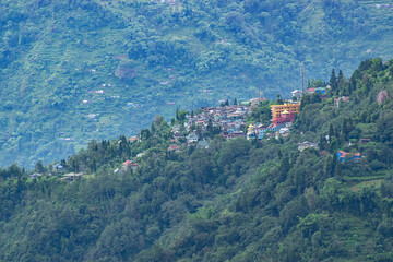 Fototapeta premium Scenic beauty of Green forests of Himalayan mountains, Okhrey, sikkim, India. Okhrey village is remote place in Sikkim where peaceful, tranquil Himalayan mountain range is enjoyed by tourists.