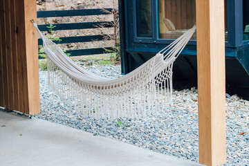 Cozy hammock set up outdoors next to a modern building in a serene landscape