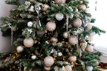 Beautifully decorated Christmas tree with ornaments in a cozy living room setting