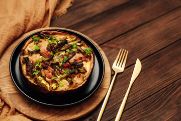 Delicious vegetable dish quiche pie served on a wooden plate with elegant cutlery