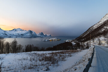 Husøy auf der Insel Senja in Norwegen an einem kalten Winterabend, Sonnenuntergang hinter...