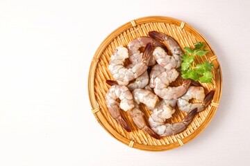 peeled fresh  shrimp in basket on white background