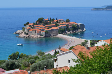 Breathtaking Panoramic View of Sveti Stefan Island in Montenegro, Showcasing its Historic Red-Roofed Buildings, Pristine Beaches, and Azure Adriatic Sea