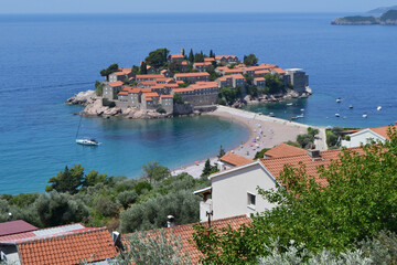 Breathtaking Panoramic View of Sveti Stefan Island in Montenegro, Showcasing its Historic Red-Roofed Buildings, Pristine Beaches, and Azure Adriatic Sea