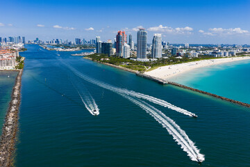 Yacht cruising near Miami Beach. Aerial view of boats on turquoise waters in Miami. Yacht retreat...