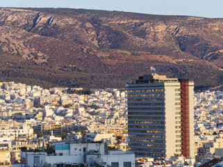 Landscape in Athens with skyscraper in view under sunset colors. Athens, Greece